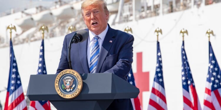 Trump giving a speech on a US Navy ship.