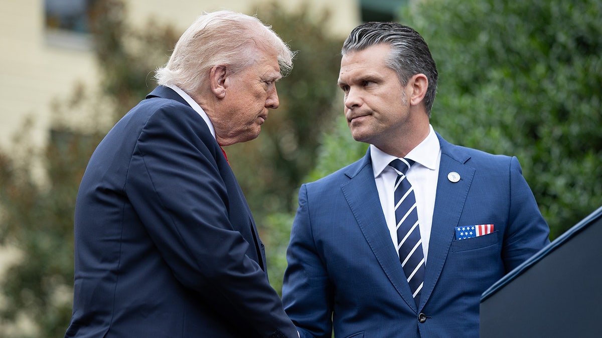 Trump shaking hands with Hegseth