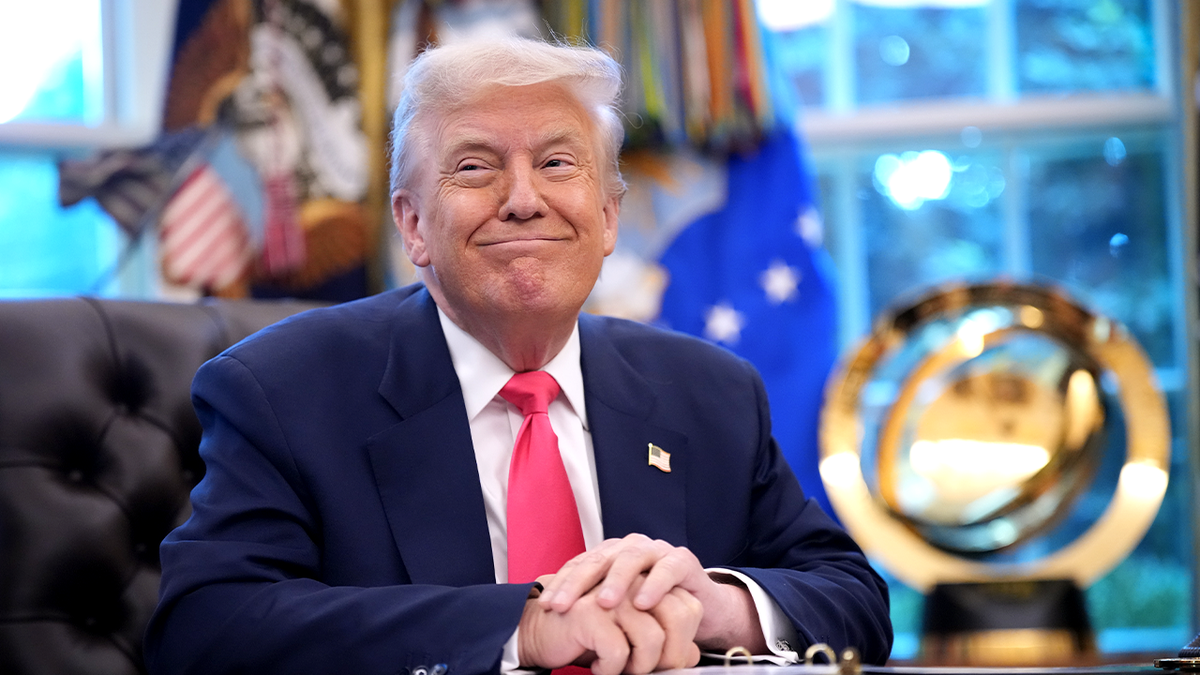 Donald Trump smiling in Oval Office
