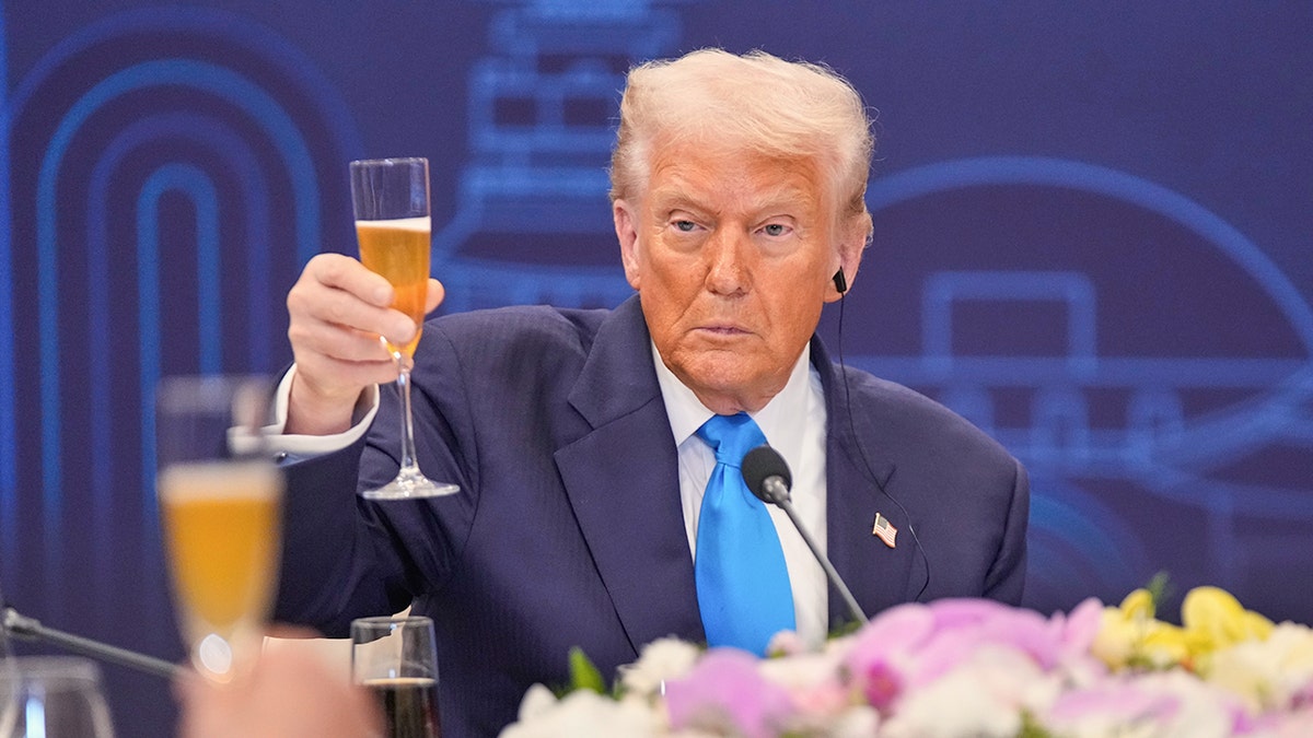 Trump raising a glass of champagne