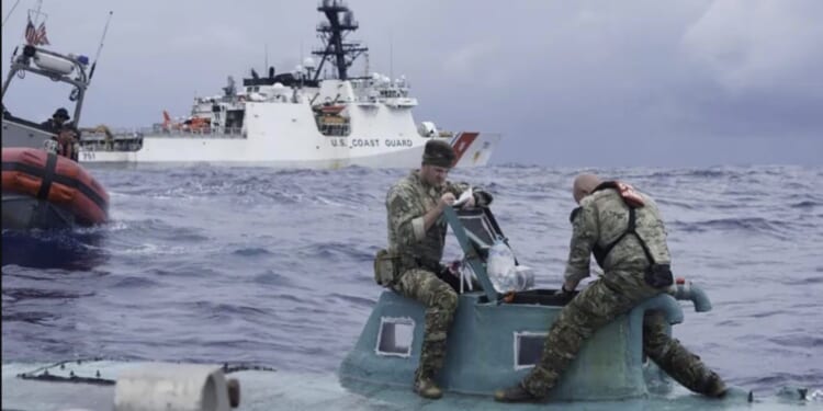 U.S. Coast Guard personnel inspect a small vessel at sea, with a larger Coast Guard ship in the background, showcasing maritime operations and rescue efforts.