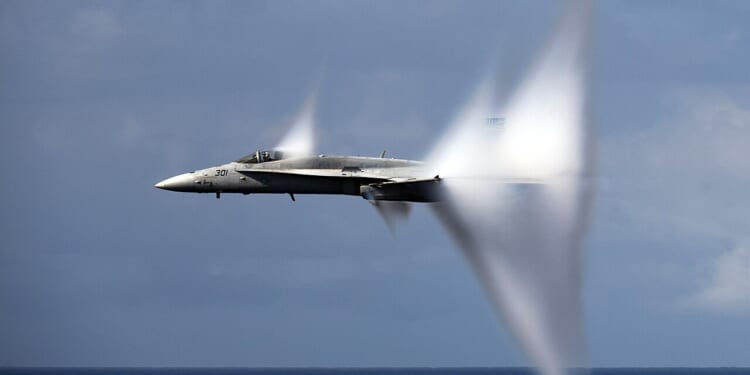 An F/A-18 Hornet breaking the sound barrier.