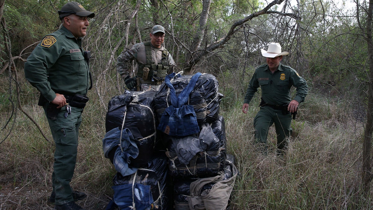 Border patrol agents and a special operations group member from the Texas Ranger Division seize 297 pounds of marijuana following a drug bust by the Mexico-U.S. border in the Rio Grande Valley sector, near McAllen, Texas,