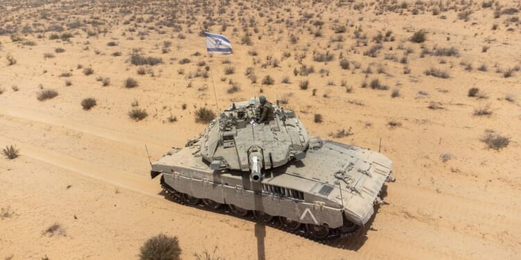 A Merkava tank with an Israeli flag.