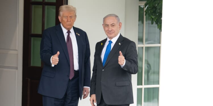 Donald Trump takes a photo with Benjamin Netanyahu at the White House.