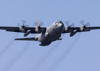 A C-130 Hercules transport plane in flight.