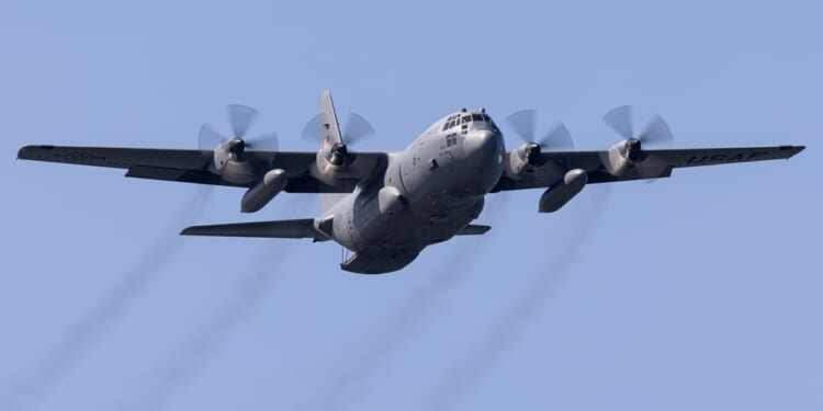 A C-130 Hercules transport plane in flight.