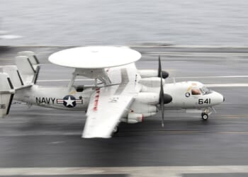 An E-2 Hawkeye landing on an aircraft carrier.