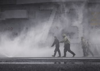 A saltwater washdown aboard an aircraft carrier.