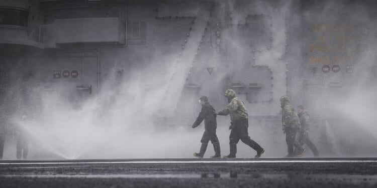 A saltwater washdown aboard an aircraft carrier.