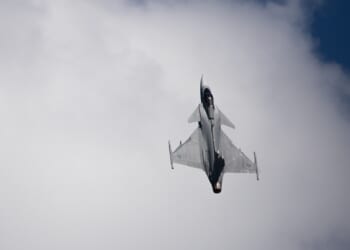 A Swedish JAS 39 Gripen flying vertically.