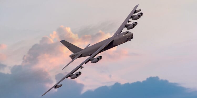 A B-52 Stratofortress turning at dusk.