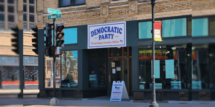Exterior of the Winnebago County Democratic Party office located at 480 N Main St, featuring a sign and nearby traffic signals.