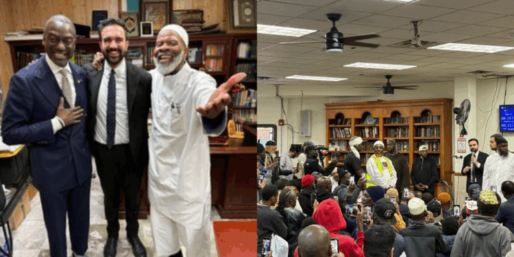 Group of men smiling together in an office setting, with a crowd gathered in a community space, highlighting engagement and connection among diverse individuals.