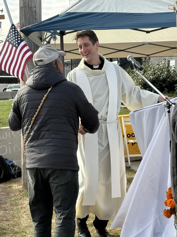 "On a day of All Saints, people should be able to receive communion. That’s a reasonable request to make,' said Father David Inczauskis, S.J., shown here speaking to one of the participants at the Nov. 1, 2025 Mass. Credit: Kathleen Murphy/CNA