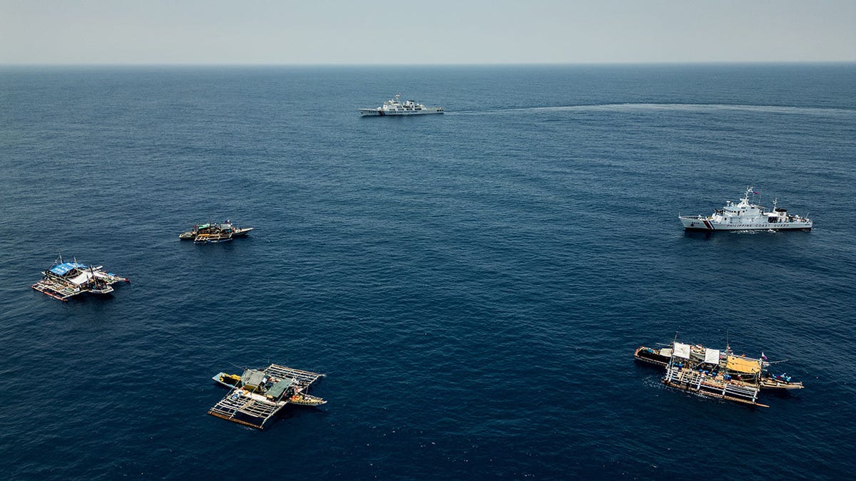 Chinese coast guard and Philippines fishing boats