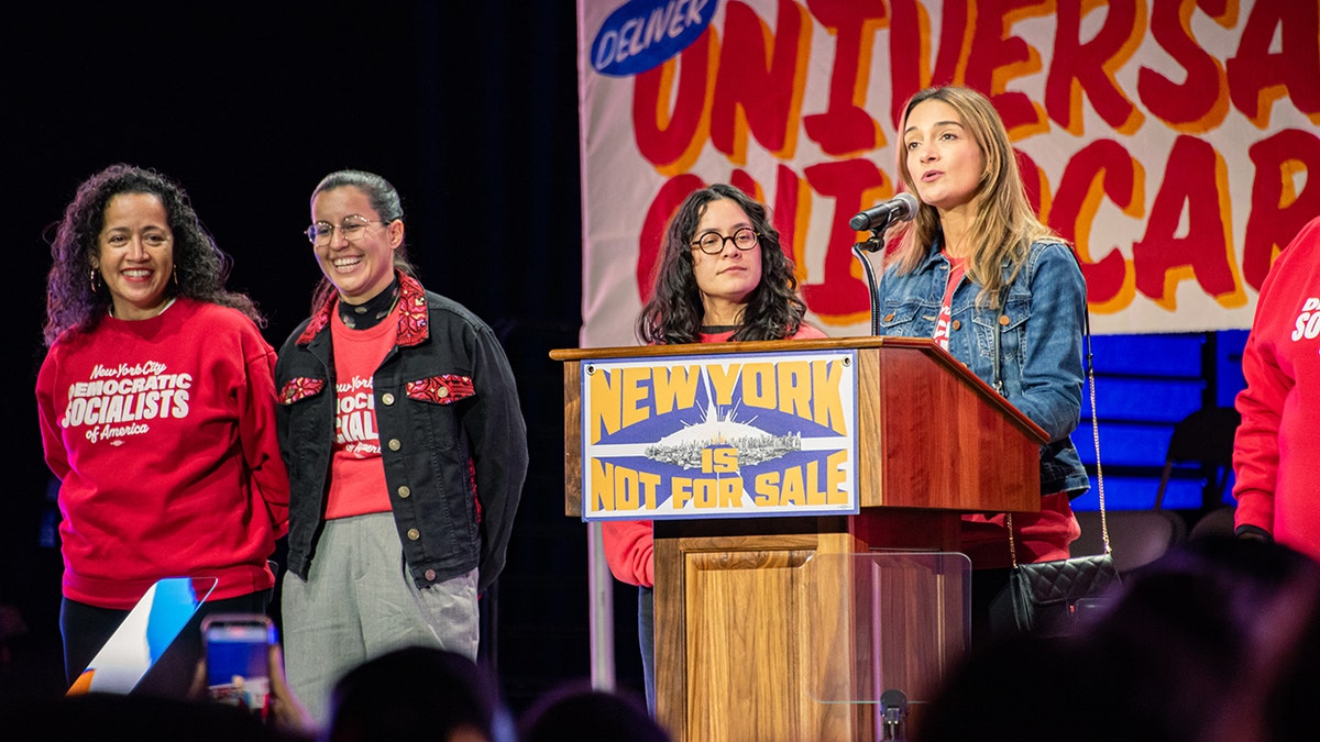 Members of the Democratic Socialists of America speak on stage at a rally for NYC mayoral candidate Zohran Mamdani