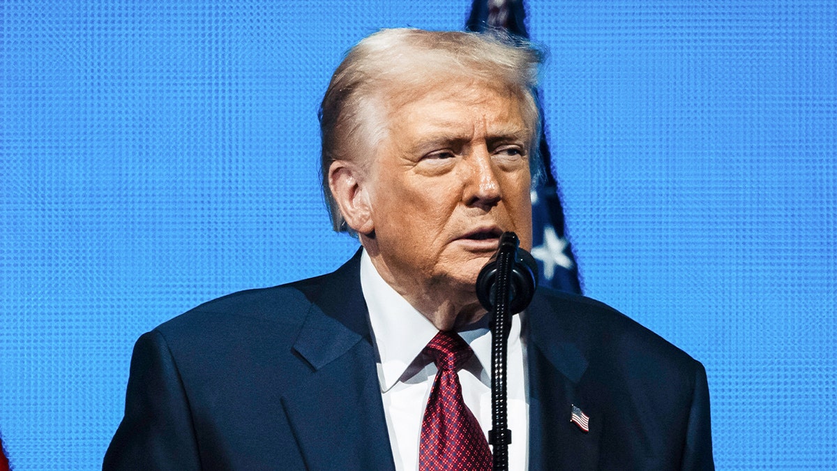 Trump speaking into a microphone