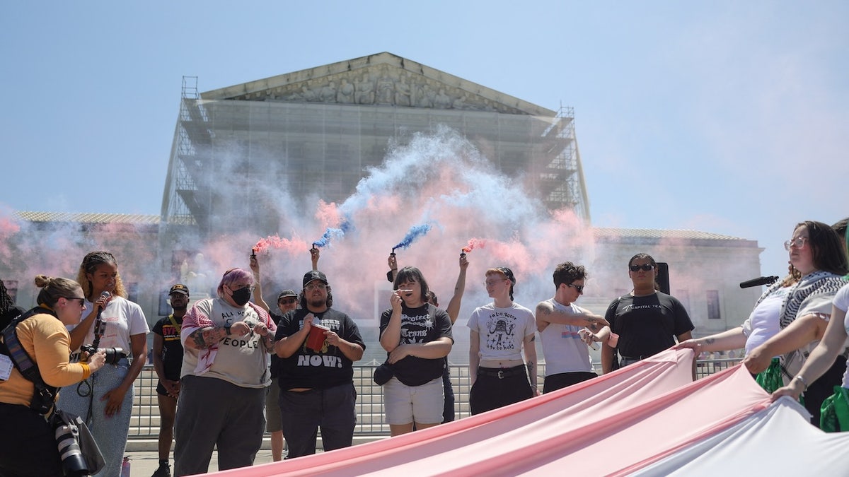 Colored smoke devices during a rally outside of the Supreme Court
