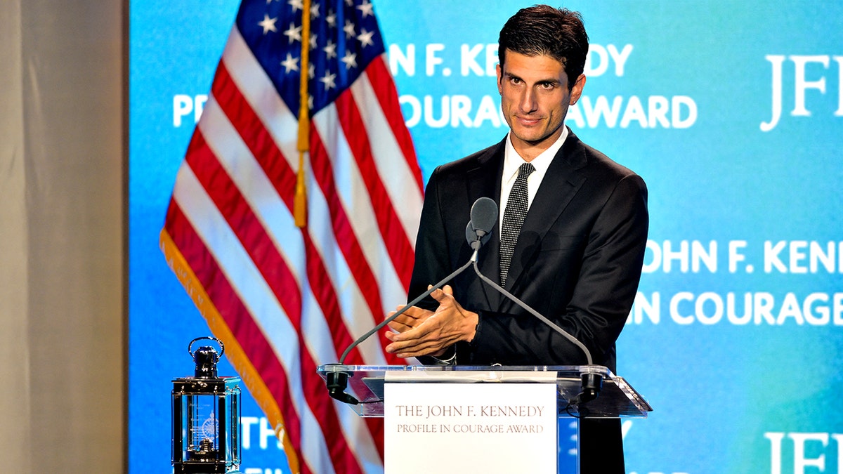 Jack Schlossberg clapping at a podium