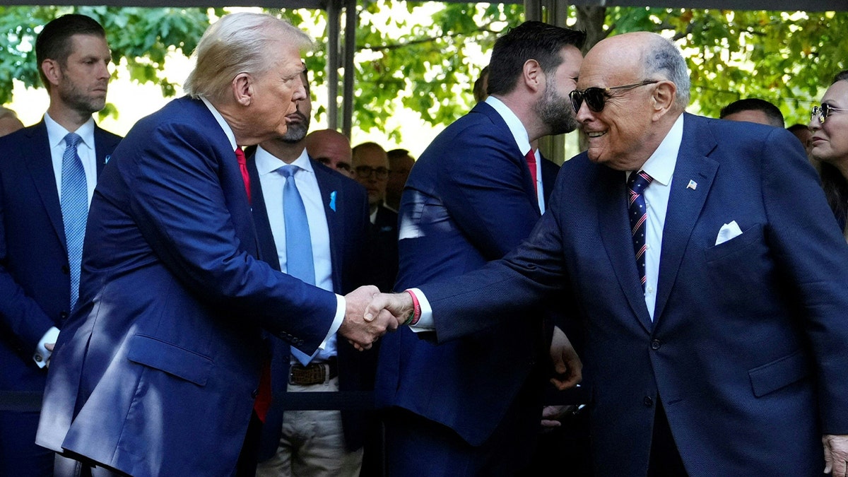 President Donald Trump shaking Rudy Giuliani's hand
