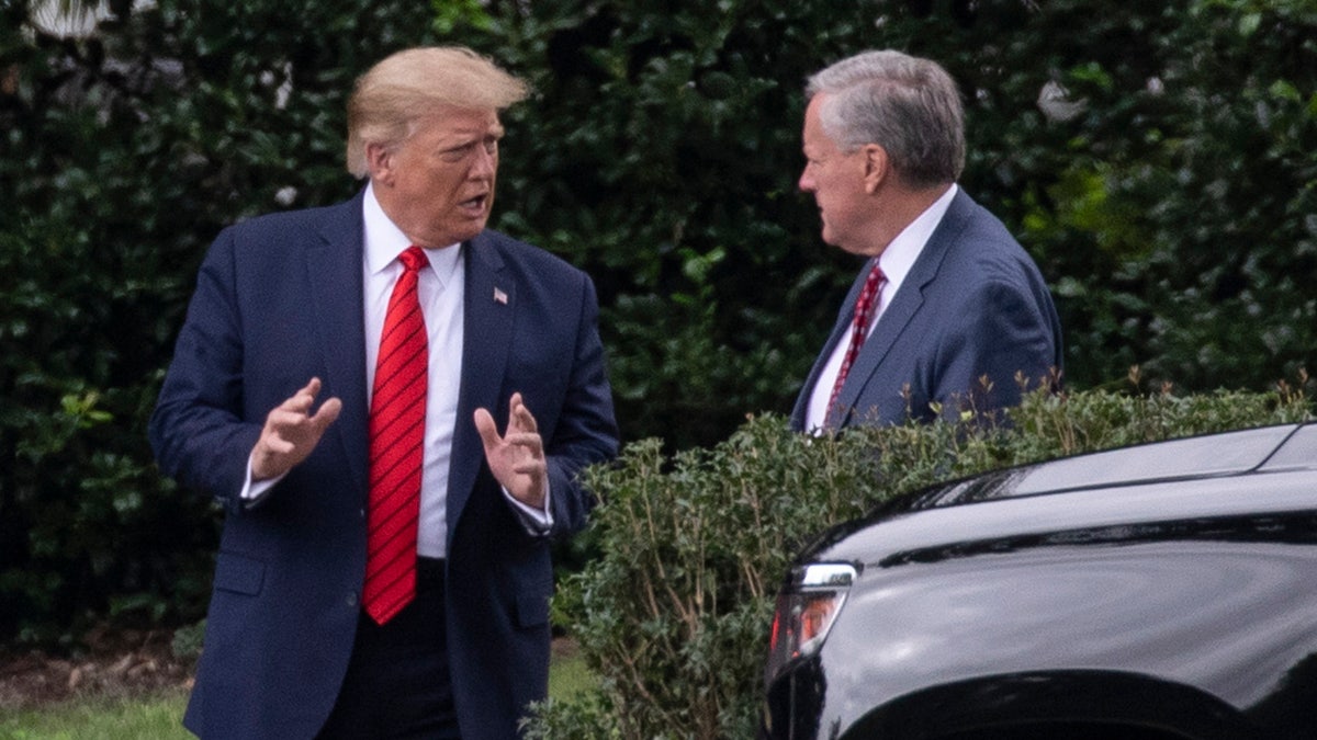 Donald Trump speaks with Mark Meadows