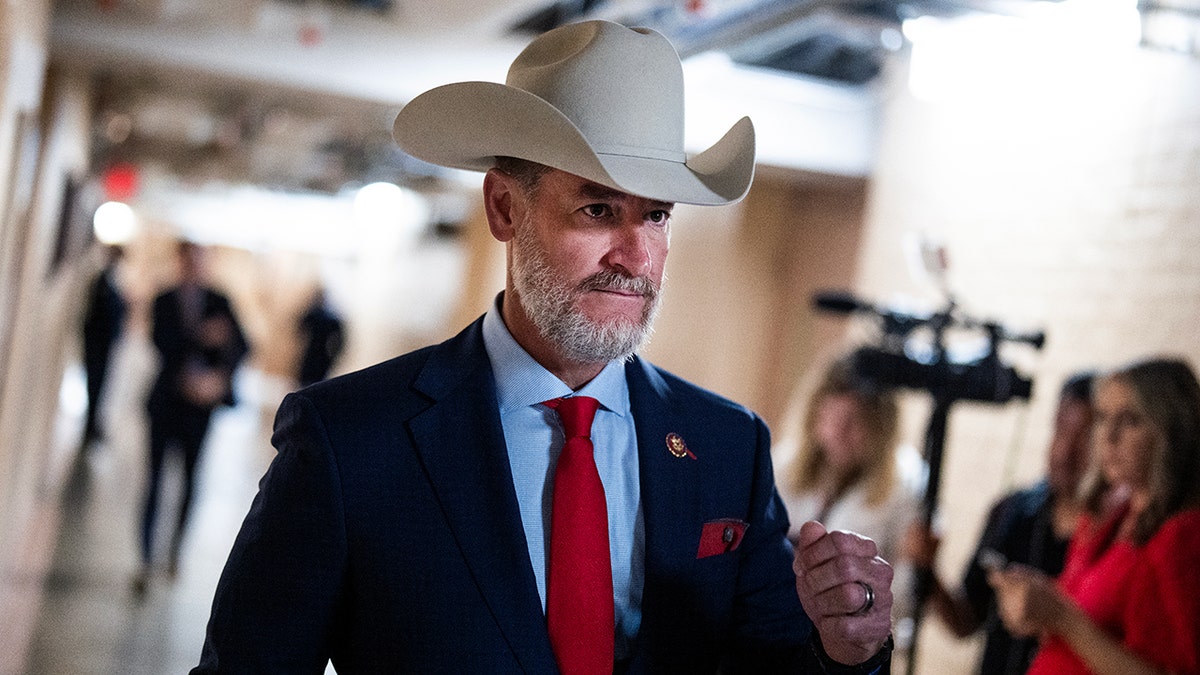 Rep. Greg Steube walks to a meeting