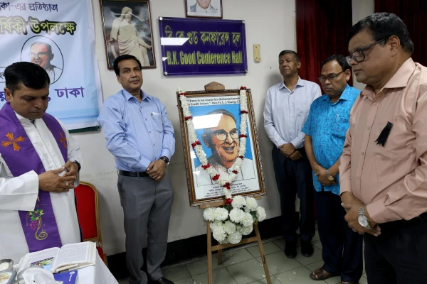 The leaders of The Christian Cooperative Credit Union Ltd. in Dhaka, Bangladesh, gather around an image of Father Charles Joseph Young, offering prayers before observing his death anniversary on Nov. 14, 2025. Credit: Stephan Uttom Rozario