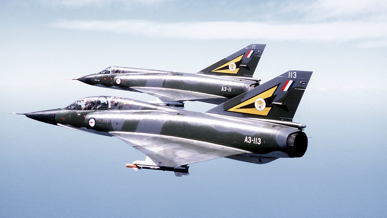 Two Mirage III aircraft in flight.