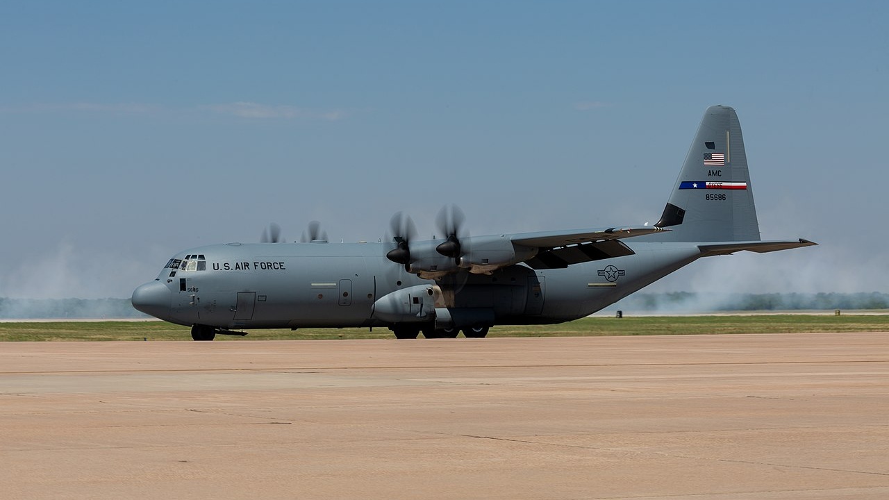 A C-130 Hercules taxiing on a runway.