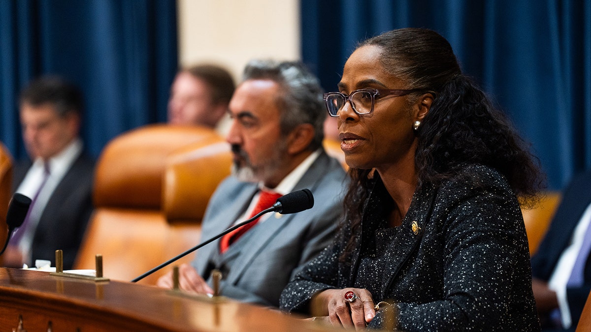 plaskett sitting during a committee hearing