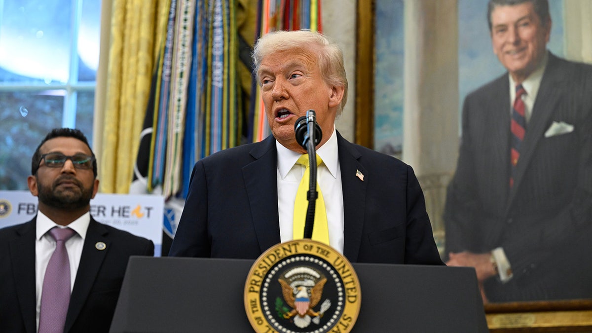 President Donald Trump speaks as FBI Director Kash Patel looks on in the Oval Office, Wednesday, Oct. 15, 2025.