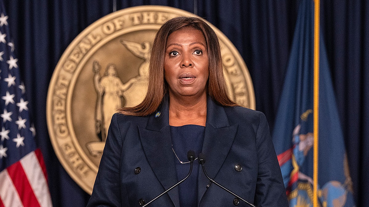 New York Attorney General Letitia James stands at a podium