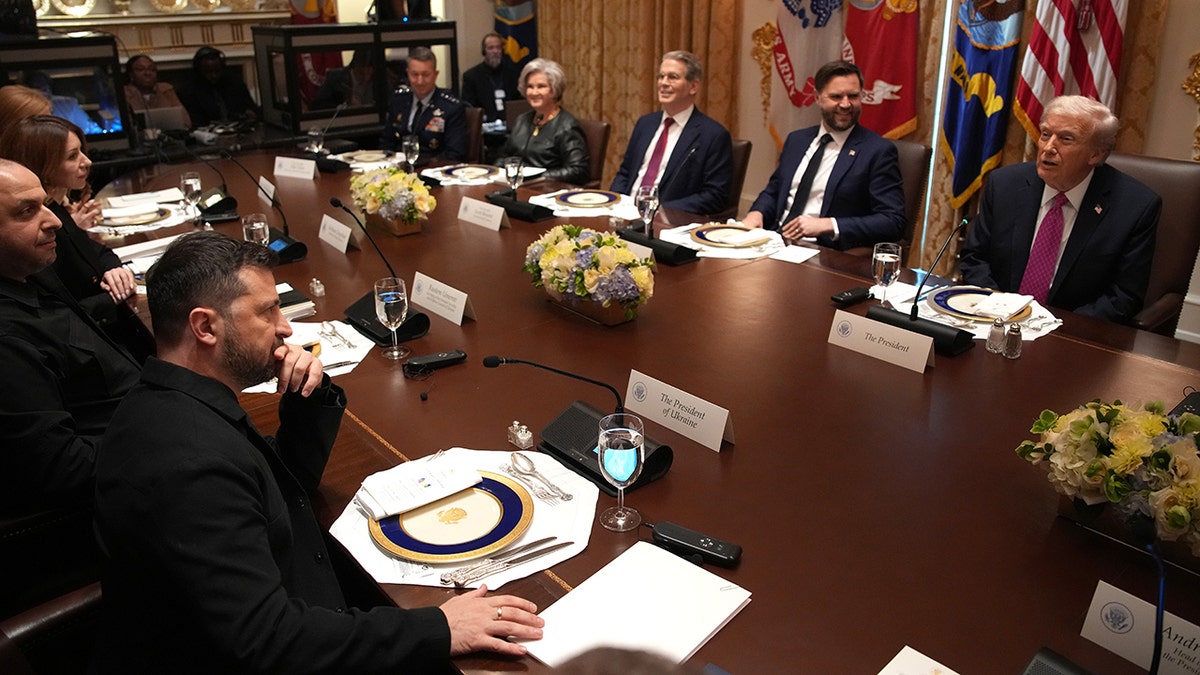 Ukrainian President Volodymyr Zelenskyy sits at table across from President Donald Trump