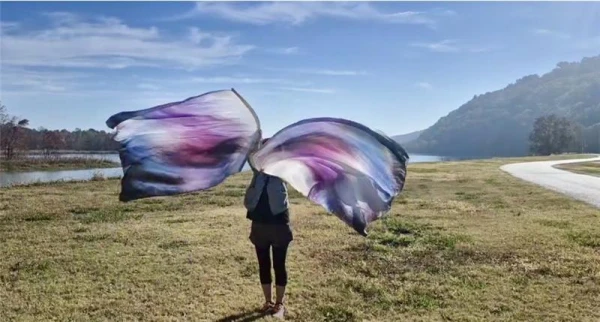 A 5K participant waves flags at first annual 5K for the Living Wall: Monument to the Unborn on Nov. 22, 2025, at Two Rivers Park in Little Rock, Arkansas. Credit: Photo courtesy of Lakey Goff
