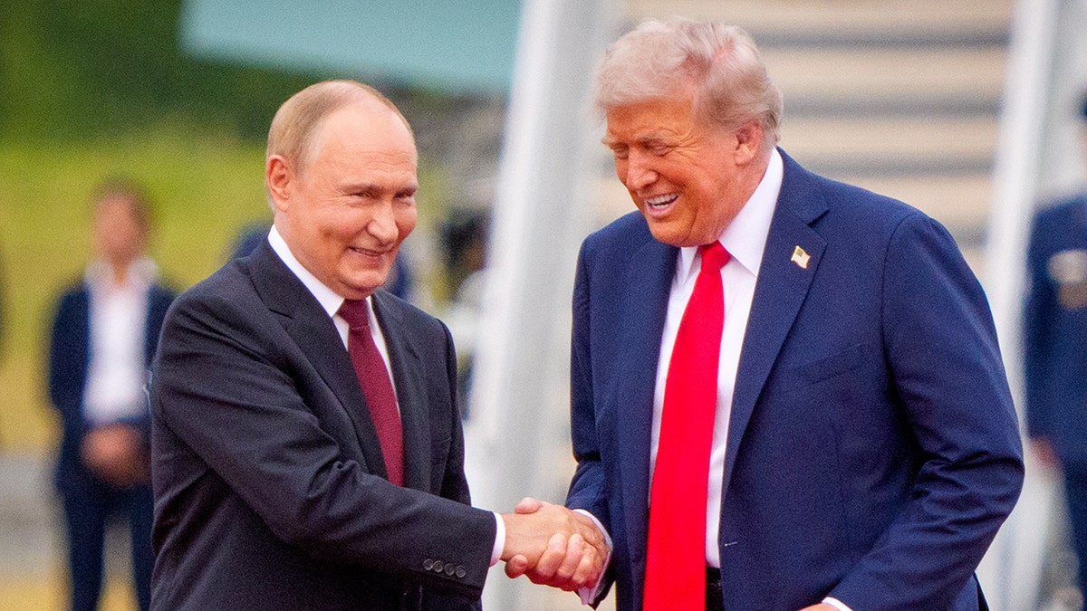 U.S. President Donald Trump shakes hands with Russian President Vladimir Putin.