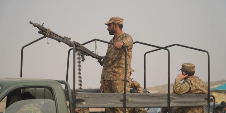 A Pakistani soldier manning a machine gun.