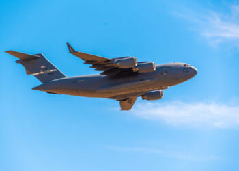 A U.S. Air Force Boeing C-17 Globemaster III passes over the city in its approach to Mather Airport.
