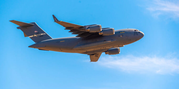 A U.S. Air Force Boeing C-17 Globemaster III passes over the city in its approach to Mather Airport.