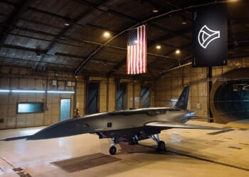 A YFQ-44 drone on display in an Anduril hangar.