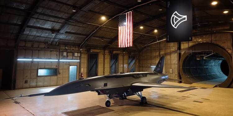 A YFQ-44 drone on display in an Anduril hangar.