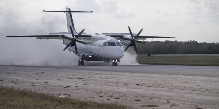 A C-146 Wolfhound landing on an airstrip.