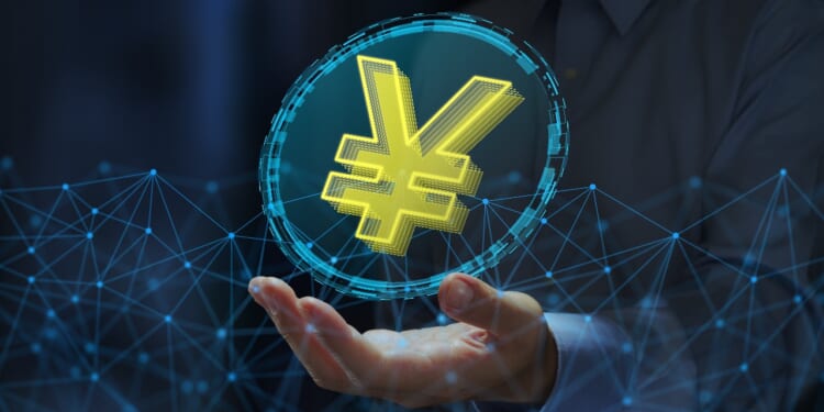JPY stablecoin or digital yen. Cryptocurrency tokens on blockchain networks. Business person holding yen sign.