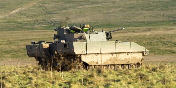 British army General Dynamics Ajax tank; (turreted, reconnaissance and strike) digitised, tracked, armoured fighting vehicle (AFV) in action.