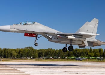 A Chinese J-16 fighter landing at an airstrip.