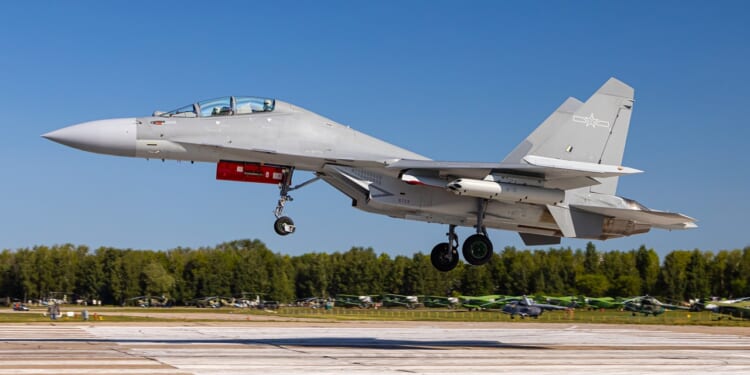 A Chinese J-16 fighter landing at an airstrip.