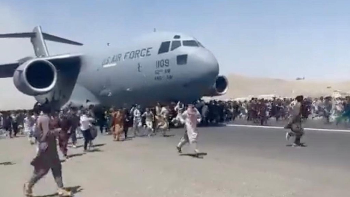 Famous image of Afghans running after an American aircraft leaving Kabul