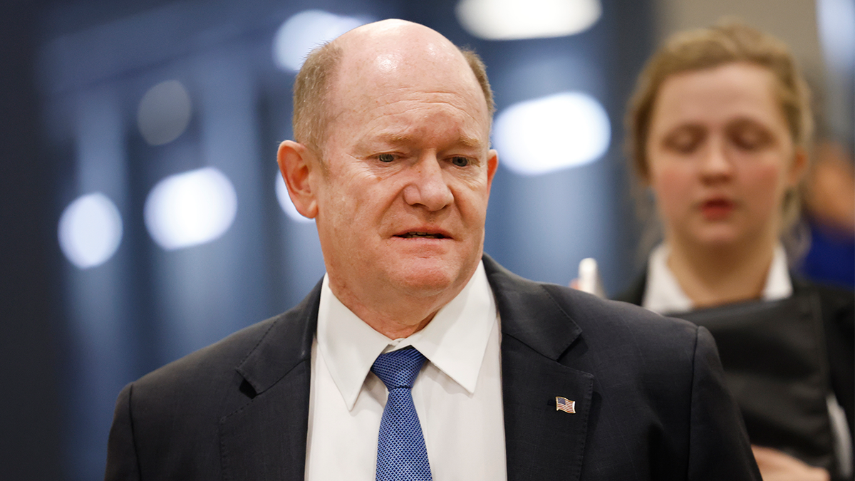 chris coons walks through the senate subway