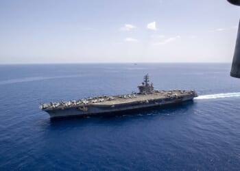 The French aircraft carrier, FS Charles De Gaulle (R91) sails alongside the Nimitz-class aircraft carrier USS Dwight D. Eisenhower (CVN 69) in the Mediterranean Sea, May 2.
