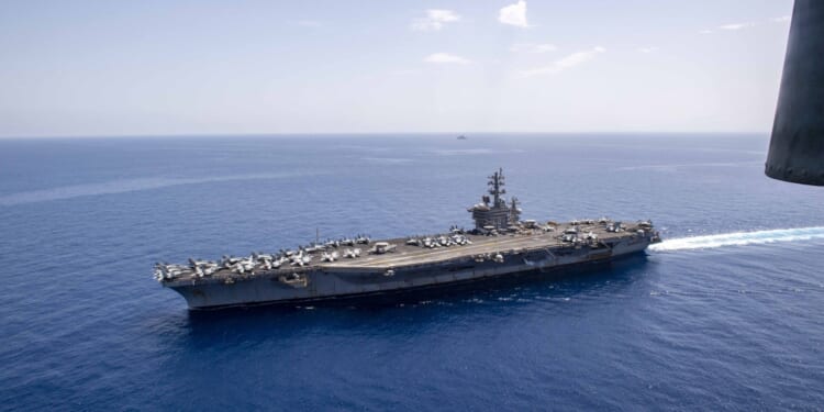 The French aircraft carrier, FS Charles De Gaulle (R91) sails alongside the Nimitz-class aircraft carrier USS Dwight D. Eisenhower (CVN 69) in the Mediterranean Sea, May 2.